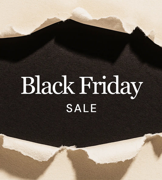 Torn beige paper revealing a black background with the words “Black Friday Sale” in bold white text.
