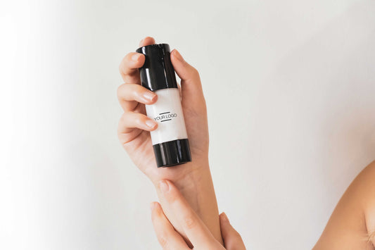  Close-up of hands holding a customizable skincare bottle, highlighting a sleek and minimal design perfect for private label branding