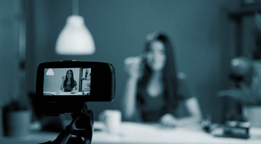 Camera recording a beauty influencer in a dimly lit room, emphasizing the importance of user-generated content (UGC) for makeup and skincare brand marketing