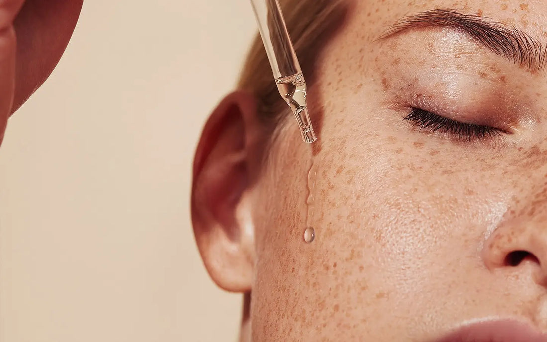 Women with eye dropper and serum on face with freckles - Blanka Beuty