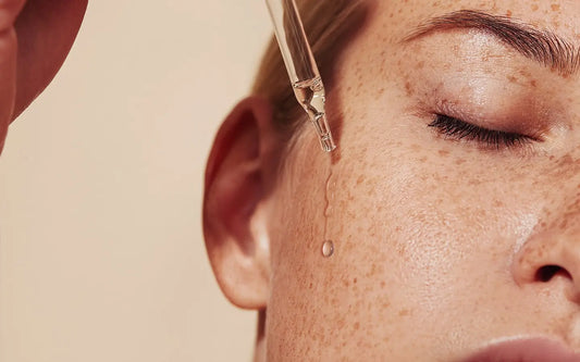 Women with eye dropper and serum on face with freckles - Blanka Beuty