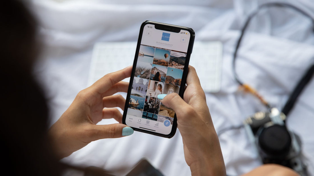 Close-up of hands scrolling through an Instagram feed on a smartphone, symbolizing the importance of personal branding and social media presence for creators