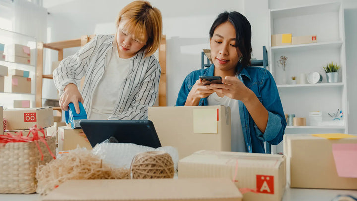 Two Asian women packing their ecommerce orders