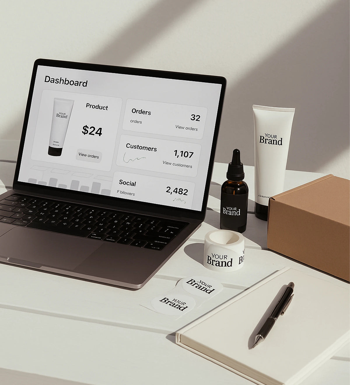Laptop displaying a dashboard with product and customer information, surrounded by branded items on a desk.