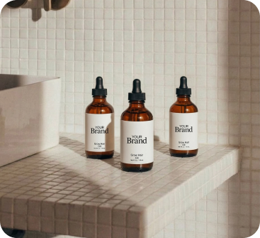 Three bottles of 'Your Brand' on a tiled surface