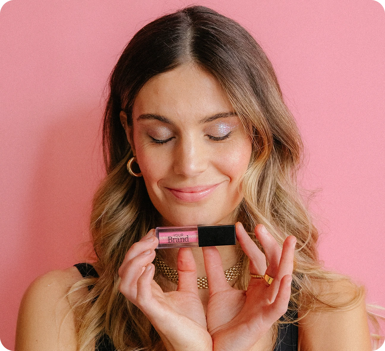 Beauty professional holding custom branded lash or brow serum bottle