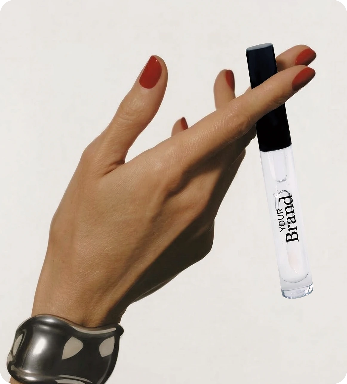 Hand holding a lip gloss with 'Your Brand' text on a white background