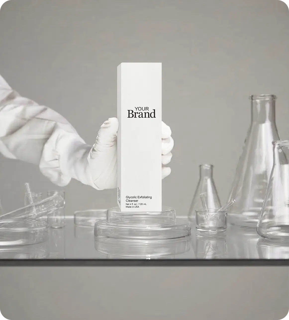 Placeholder image with a hand holding a cylindrical product packaging labeled 'Your Brand' against a gray background.