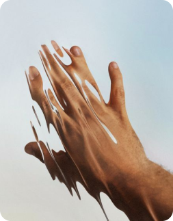 Two hands reaching towards each other with a blurred background