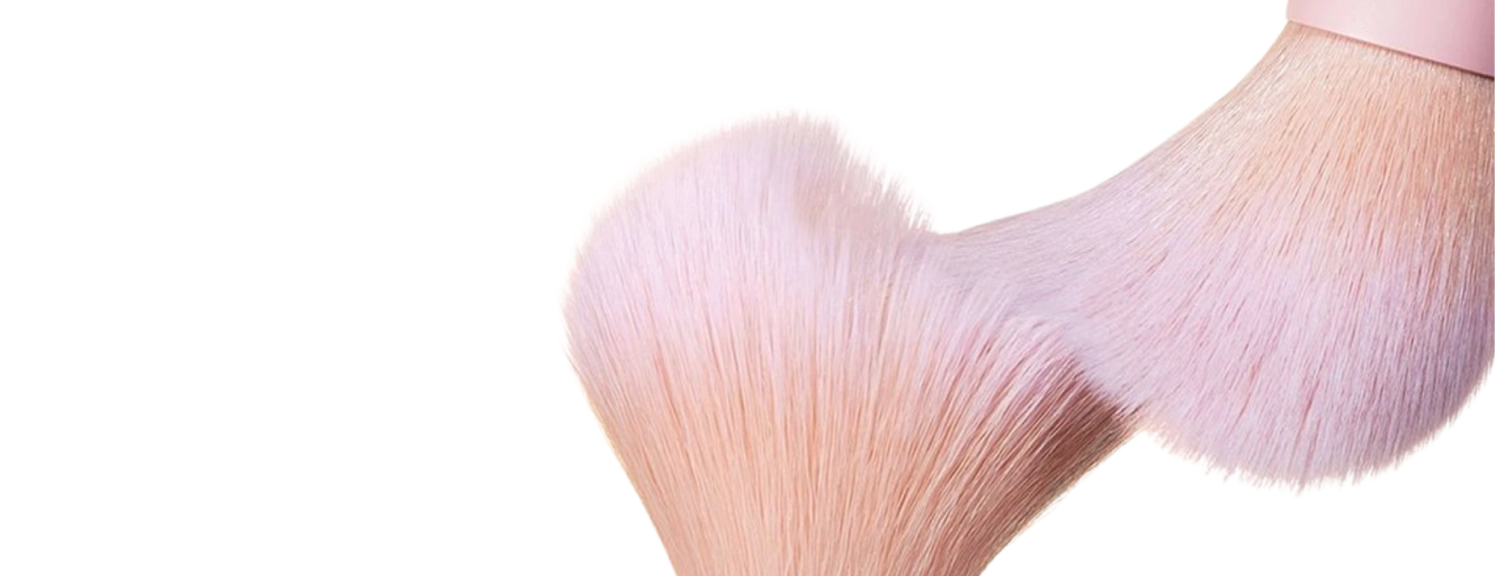 makeup brushes with pink blush on them