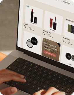 Person using a laptop with a cosmetic website open on the screen