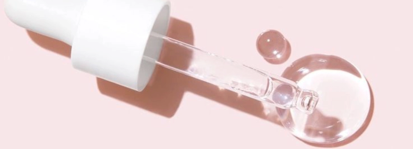 image of beauty product dropper with serum coming out