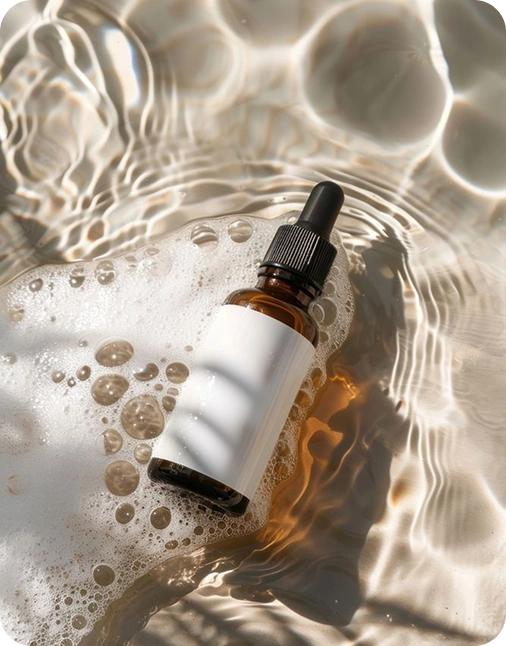 Brown glass dropper bottle with white silicone sleeve on water surface