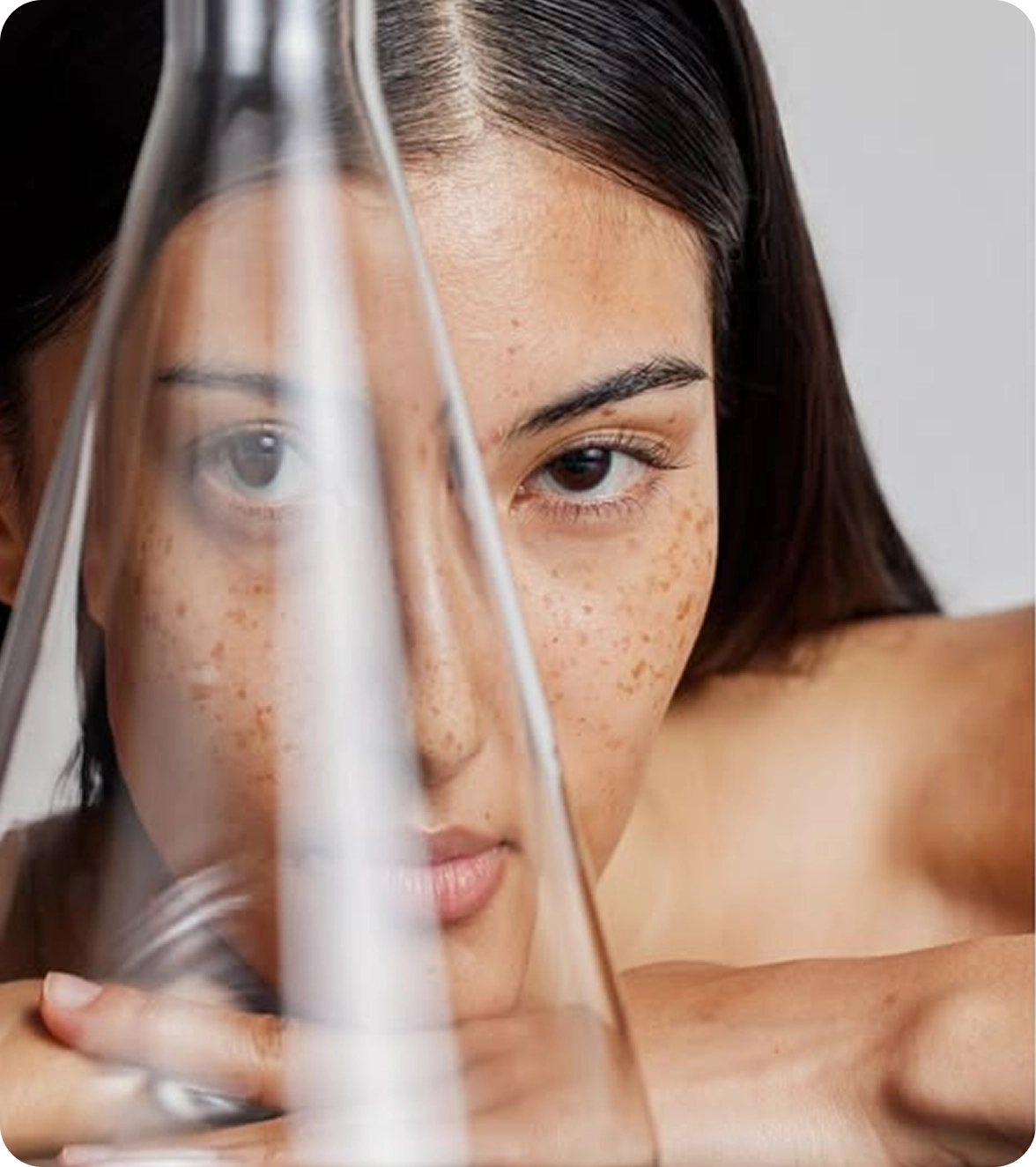 Woman holding a transparent object with a blurred background