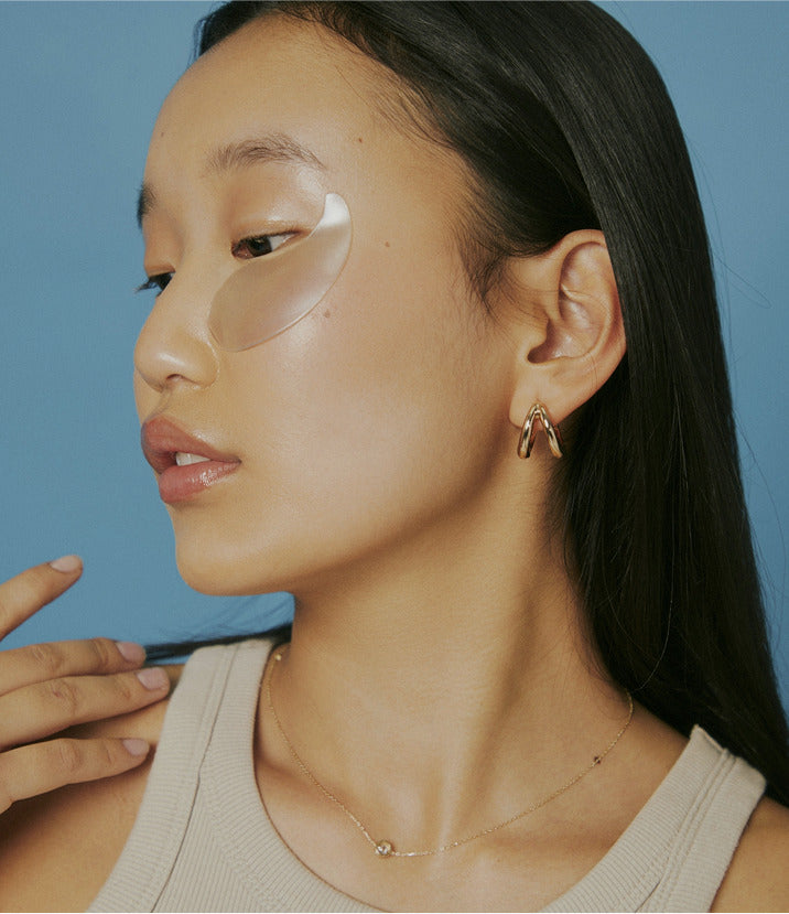 Female with under eye masks.
