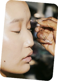 Eyelash extension application with precision tweezers on client