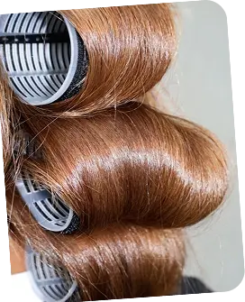 Professional hair salon color treatment with rollers and custom branded products