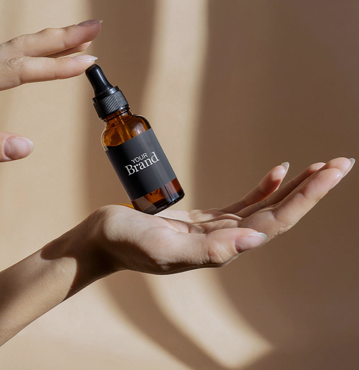 hand holding serum dropper with your brand on it