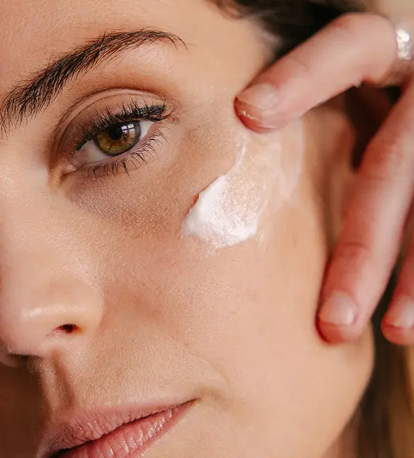 Professional white label skincare product line with minimalist packaging including serums, lotions, and treatment bottles