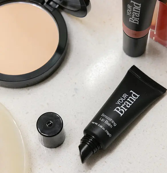 High-end custom branded makeup compact with pressed powder and mirror next to lipstick