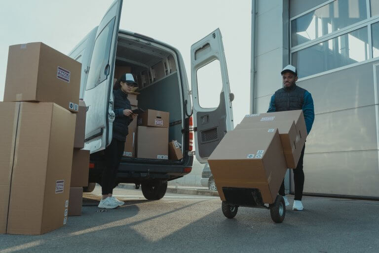 courier unloading boxes from delivery van