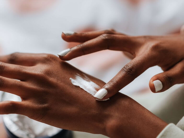 Women applying Blanka private label skin care moisturizer to her hand